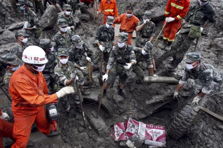 Rescuers search for victims after a landslide in Gongshan county, in southwest China's Yunnan province, Friday, Aug. 20, 2010. Rescue crews searched Friday for scores of people left missing and feared dead in southwestern China after torrential rains triggered massive mudslides during a summer plagued by deadly rains and flooding. (AP Photo) ** CHINA OUT **